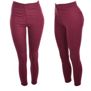 Macro detail of high-waist burgundy pencil pants showing elastic fabric and slim fit