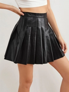 Detailed close-up of pleated PU leather mini skirt showing fine texture and uniform folds