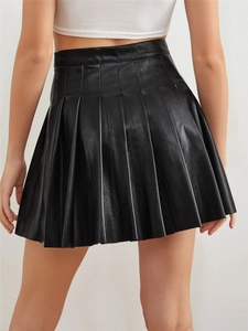 Rear view of a black high-waisted PU pleated mini skirt showing fit and faux leather texture