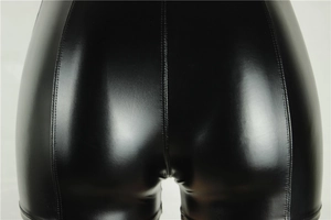 Detailed close-up showing the glossy black PU leather fabric and stitching on slim fit shorts