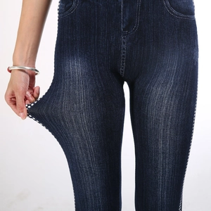 Deep blue faux denim leggings with white side dots showing high elasticity and stretch