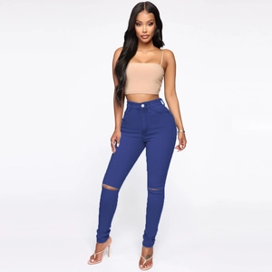 Detail showing high-waist blue skinny jeans with distressed ripped knee design for women
