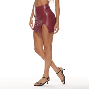Detail view of burgundy high-waisted PU leather mini skirt with side slit on model