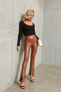 Detail of high waisted brown PU leather flared pants with vertical slits at the ankles