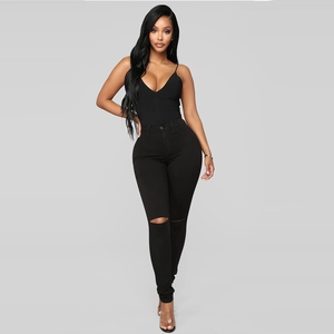 Women's black deep V-neck bodysuit paired with high-waist ripped skinny denim jeans