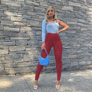 Full body shot of model in high waist slim trousers and light blue one-shoulder top