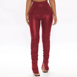 Close-up of ruched detail and split hem on dark red metallic faux leather high waist trousers