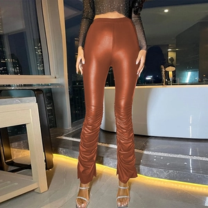 Detail of caramel high waist PU leather pants with stylish ruched stacked design