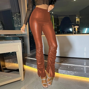 Detail of ruched faux leather pants in caramel featuring split hems and high-waist design