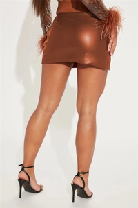 Detail view of the sleek dark brown PU leather mini skirt with side slit and glossy finish