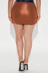 Rear view of sleek caramel faux leather mini skirt with high-gloss finish and slim fit