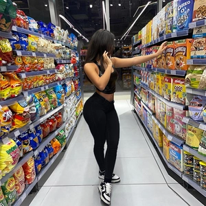 Detailed view of high-waist stretchy black skinny jeans and sleeveless tank top set