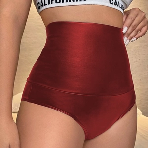 Macro shot of high-waist red metallic PU shorts featuring a glossy wet-look finish