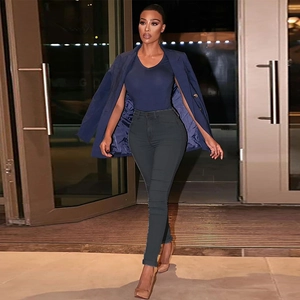 Detailed full view of high waist skinny jeans in dark grey styled with an urban outfit