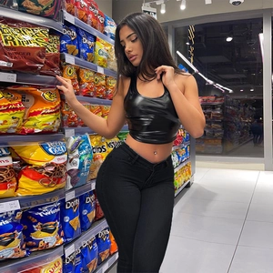 Slim fit black cropped faux leather top and high waist skinny denim jeans on a model