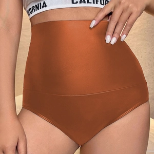 Detail view of high-waist seamless faux leather shorts in deep caramel with tummy control