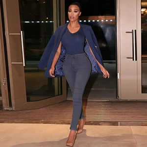Detail of high-waisted navy slim trousers styled with a matching blazer for a chic look