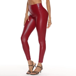 Détail d'un legging taille haute en similicuir bordeaux brillant avec une coupe moulante