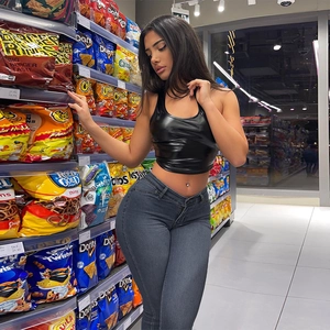 Close-up of high-waist slimming dark grey denim jeans paired with black coated crop top