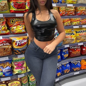 Detail of high-waist stretch denim pencil pants and glossy black halter top