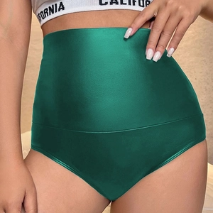 Macro shot of high-waist dark green satin shorts with a glossy finish and tummy control