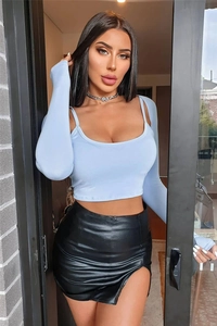 Close-up of black PU leather mini skirt with side slit detail and smooth texture