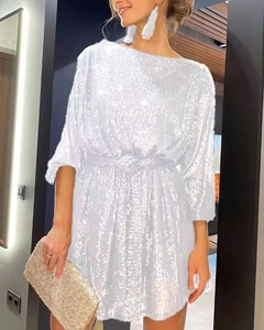 Detail of white sequin cocktail dress featuring boat neck and shimmering texture