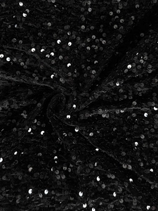 Macro shot of black sequin fabric detail showing high-end texture and shiny craftsmanship