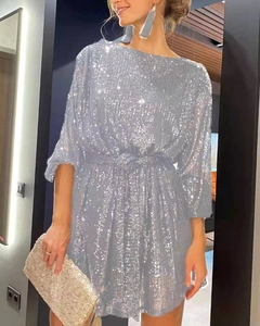 Detail of silver sequin cocktail dress with waist tie and off-shoulder neckline