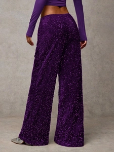 Detail of high-waisted dark purple sequin wide leg pants showing texture and sparkle