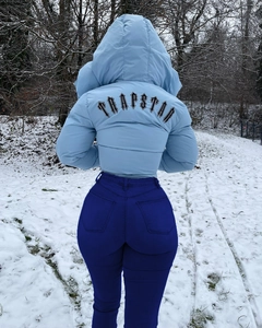 Close-up of baby blue hooded down jacket featuring gothic logo embroidery on the back
