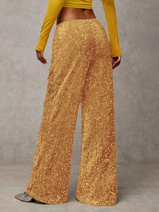 Detailed back view of high-waisted golden sequin wide-leg trousers for party wear
