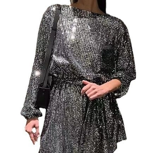 Detail of shimmering silver-black sequins on elegant long-sleeved evening dress
