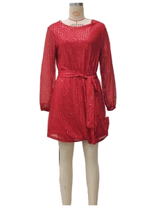 Detail of red sequin dress featuring waist belt and long sleeves for party wear