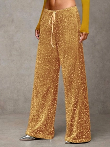 Detailed shot of golden sequin wide-leg pants with adjustable drawstring waist design