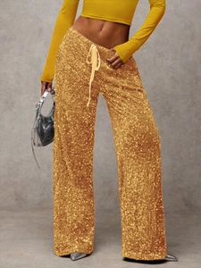 Detail view of the golden sequins fabric and drawstring waist on high waist wide leg pants