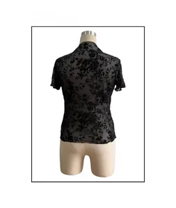 Detail view of the sheer mesh back with floral flocking on the black short sleeve top