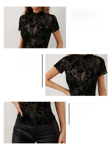 Detail view showing neckline, cuffs and hem of black floral flocked mesh short sleeve top