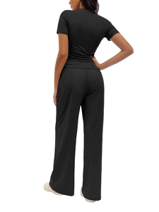 Rear view of black two-piece set featuring short-sleeve top and high-waist wide-leg pants