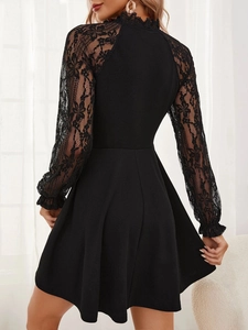 Detailed back view of a black lace sleeve dress showing sheer floral patterns and elegant cut
