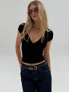 Close-up of a deep V-neckline and crossed waist detail on a black slim-fit cotton T-shirt