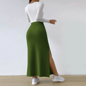 Detail view of the green ribbed knit maxi skirt featuring a high waist and side slit design
