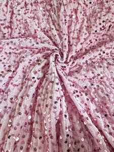 Detail of pink sequin fabric showing textured velvet base and metallic shimmer