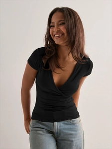 Detail of a black slim-fit V-neck wrap T-shirt in high-quality elastic knitted fabric