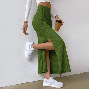 Detail view of grass green ribbed knit maxi skirt featuring a high waist and side slit