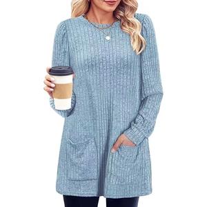 Detail of light blue rib-knit sweater showing side pockets and soft ribbed texture