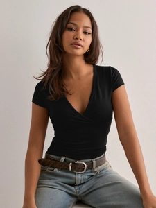 Slim fit black wrap-style V-neck T-shirt paired with blue washed jeans and belt