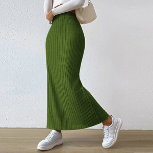 Detail shot of green ribbed knit maxi skirt with high waist and elegant side slit