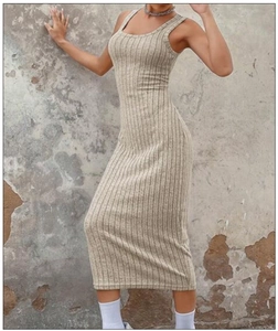 Detail of ribbed knit fabric texture on a slim fit oatmeal midi dress with side slit