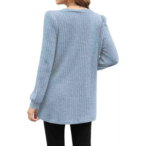 Detail view showing the vertical ribbed knit texture and back design of a light blue sweater